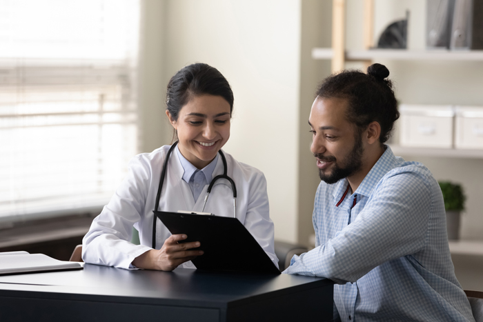 Doctor showing a clipboard to a patient